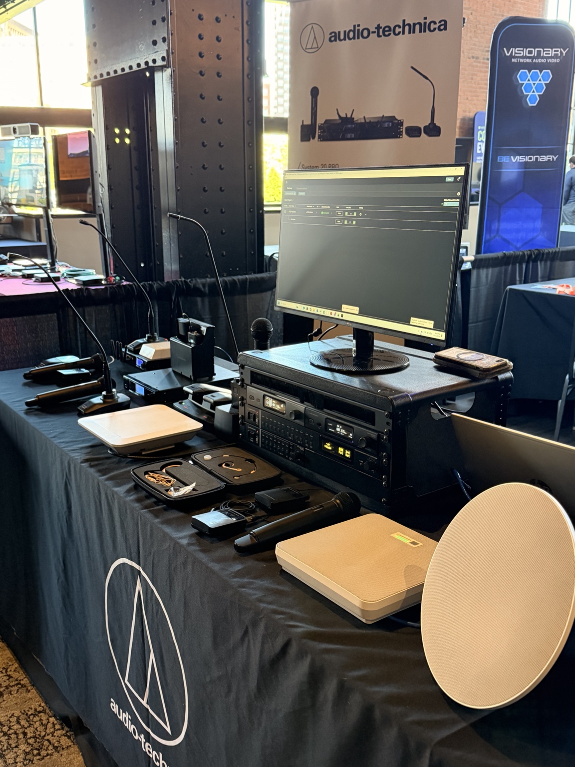 Audio-Technica microphones and conferencing equipment at a demonstration display